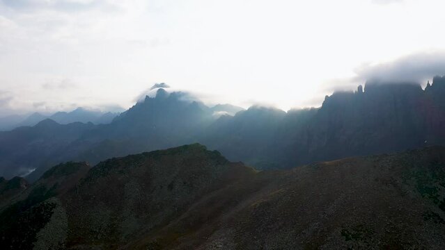 Flying with a drone through the clouds on the magnificent peaks of the Altiparmak Mountains in Rize. High peaks on a wonderful morning, natural landscape. Kackar, Rize.
