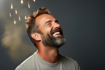 young handsome man smiling wearing casual clothes happy smiling looking up and to the side against a green background. copy space.