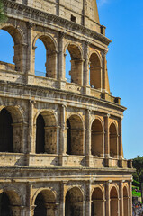 Fototapeta premium Front view, medium distance of, a section of, Roman Colosseum, against a clear, blue sky