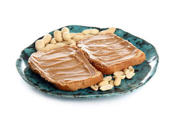 Plate of toasts with peanut butter and nuts on white background