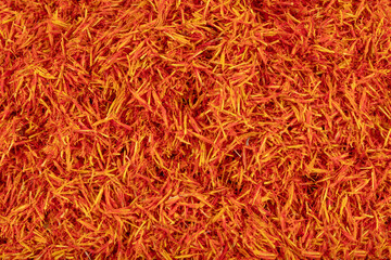 Safflower petals (Saffron substitute) Safflower (Carthamus tinctorius) also known as bastard saffron dry red flowers heap top view.