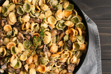Orecchiette with Mushroom Thyme Sauce in a Skillet: Pasta and mushrooms in cream sauce served in a large saute pan