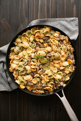 Orecchiette with Mushroom Thyme Sauce in a Skillet: Pasta and mushrooms in cream sauce served in a large saute pan