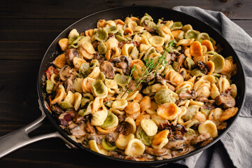Orecchiette with Mushroom Thyme Sauce in a Skillet: Pasta and mushrooms in cream sauce served in a large saute pan