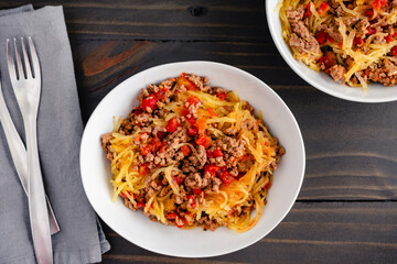 Spaghetti Squash Bolognese with Tomatoes and Ground Beef: Bowls of spaghetti squash served with a ground beef and tomato sauce