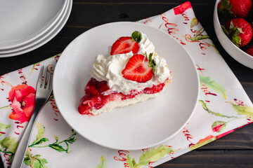 Slice of Strawberry Cream Pie with Whipped Cream: Piece of strawberry pie topped with whipped cream and fresh strawberries