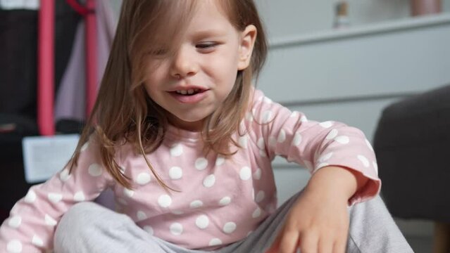 One girl caucasian toddler child eat macaroni pasta at home with hands