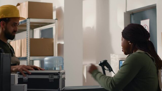 Warehouse employee asking manager for help, unsure what to do with fragile special parcel delivery request, wanting to use hard case protective suitcase to avoid issues during shipment