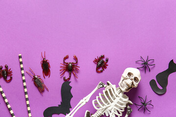 Halloween composition with skeleton, candy bugs and bat on purple background