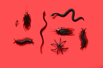 Halloween composition with different candy bugs on red background