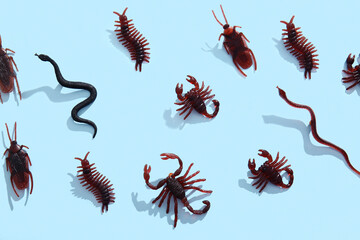 Halloween composition with different candy bugs on blue background