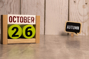 October 26th. October 26 wooden cube calendar with blur objects on background.