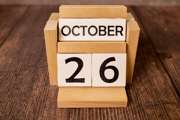 October 26th. October 26 wooden cube calendar with blur objects on background.