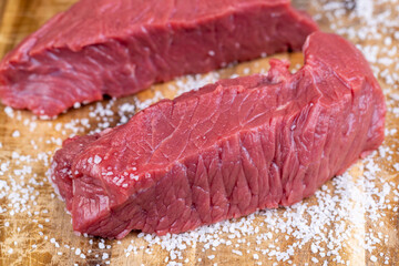 sliced piece of fresh raw beef during salting