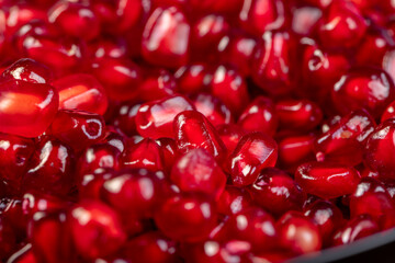 Grains of red ripe pomegranate close up