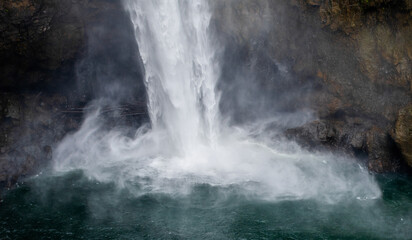 Fototapeta na wymiar Misty splash at the base of Snoqualmie Falls, Washington.