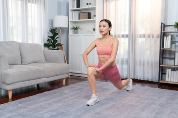 Fototapeta na wymiar Young attractive asian woman in sportswear stretching before fitness exercise routine. Home body workout with healthy athletic woman warming up. Vigorous