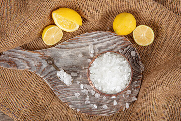 Lemon salt or Citric acid on wood background. Citric acid or lemon salt in wooden bowl. Lemon salt...