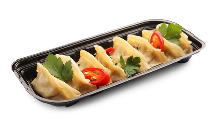 Delicious gyoza (asian dumplings) with sesame, parsley and pepper isolated on white