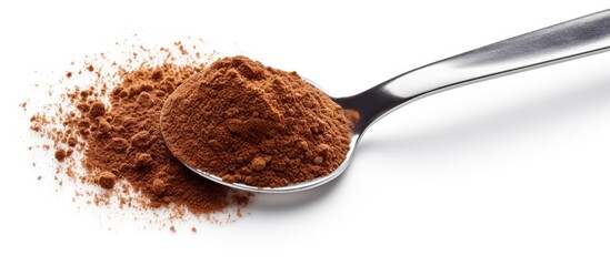 Dispensing instant coffee or coffee powder with a stainless teaspoon on a white background - obrazy, fototapety, plakaty