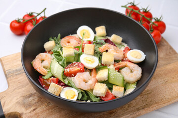Delicious Caesar salad with shrimps on table, closeup
