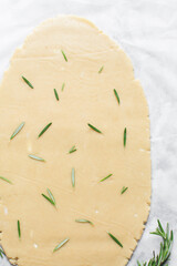 Top view of rolled out rosemary sugar cookie dough, process of making cut out sugar cookies