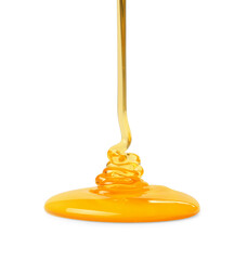 Pouring tasty natural honey isolated on white