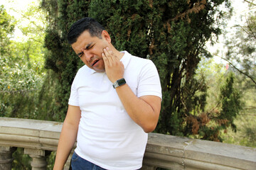 40-year-old dark-skinned Latino man suffers from pain in his teeth, molars and gums due to infection