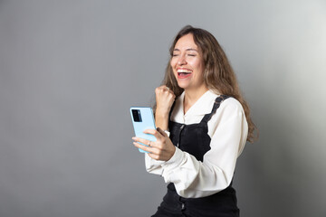 Young Woman with Smartphone and Vintage Clothing, Portrait of Woman with Smartphone and Retro Style...