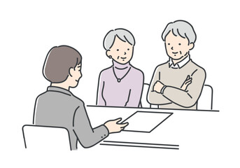 担当者の説明を聞くシニア夫婦