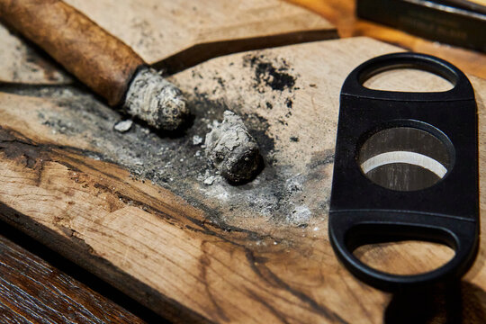 Exquisite Cuban Cigar with Cutter on Wooden Table