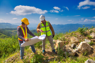 Two engineer man discuss together for the construction in far away land that cover with the forest.