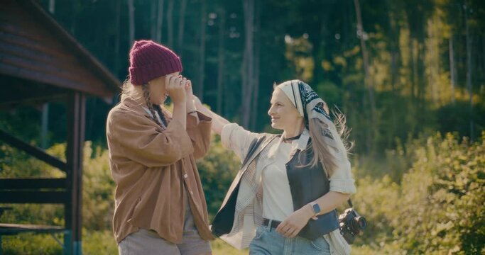 Female Friends Walking Together In Forest During Vacation
