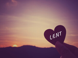 Fototapeta premium Lent Season,Holy Week and Good Friday concepts - Lent text with heart shaped in purple vintage background. Stock photo.
