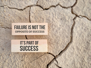 Inspirational motivational quote. Failure is not the opposite of success, it's part of success. Text on wooden blocks background.