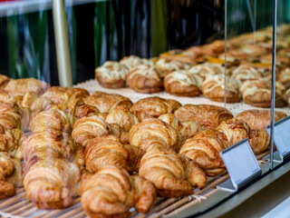 assorted freshly baked croissants presented in the display case 