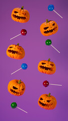 Composition of halloween pumpkins and sweets isolated on a background in vertical format