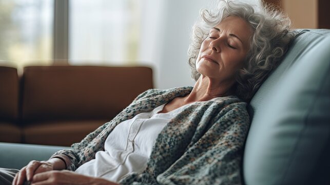 Depressed elderly woman lying on the sofa Depression, ADHD, mental health problems