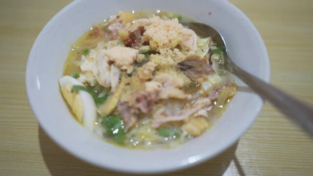 A bowl of Soto Koya Lamongan, Indonesian food curry with chicken meat and vegetables originally from East Java