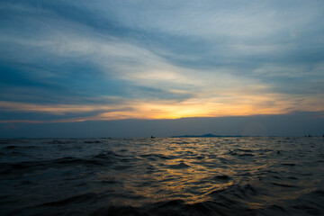 
The sea in the evening and children having fun playing in the water. The sun sets.