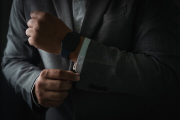 Man checking time on his smartwatch device Close-up display clock checking lifestyle communication phone mobile touch app technology - Powered by Adobe
