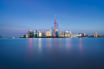 Illuminated Shanghai Skyline Reflecting On River