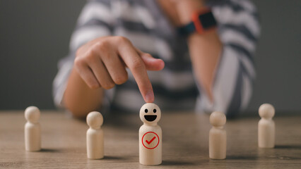Woman pick a happy face wooden figure. Customer rating employees by service experience, Human...