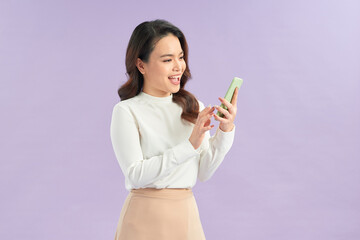 Cheerful asian young woman using smartphone.