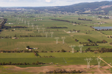 Power Lines Crossing Through Green Countryside 