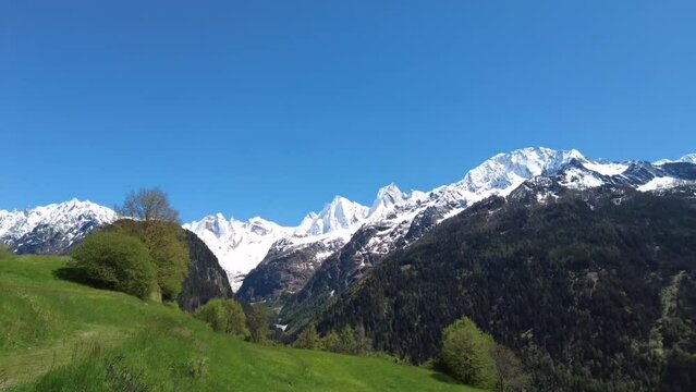 Video panorama of the snow covered Swiss Alp mountain range Sciora viewed from the village Soglio in the Bergell Valley, canton of the Grisons, Switzerland.