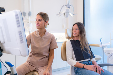 Patient and dentist looking at results in a screen