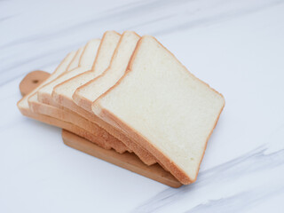 sliced white bread on the wooden cutting board