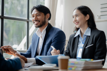 A group of businessmen and marketers meet in a company meeting room, a group of investors and executives plan marketing plans to find ways to make profits and grow. Marketing planning meeting ideas.