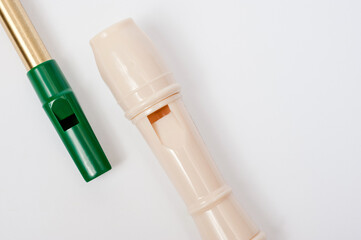 Irish whistle and block flute are longitudinal flutes with a whistle device and playing holes.